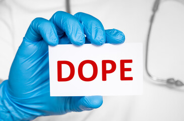 Doctor holding a card with text DOPE slang word for an euphoria-producing drug Cannabis Heroin...