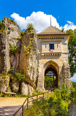 Fototapeta na wymiar Gate tower and limestone rocky defense walls of medieval royal Ojcow Castle on Cracow-Czestochowa upland in Lesser Poland