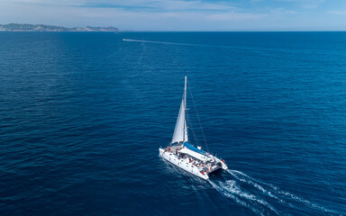 Aerial shot of yacht cruise at sea in Ibiza Spain - obrazy, fototapety, plakaty
