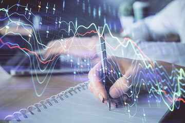 Double exposure of forex chart drawing over people taking notes background. Concept of financial analysis