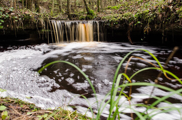 Long exposure waterfall on small river Olupite in Renda, Latvia
