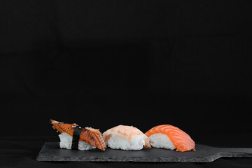Close up of sashimi sushi set on tray on black background 