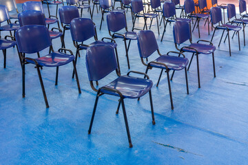 Empty blue chairs in a conference hall