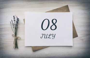 july 08. 08th day of the month, calendar date.White blank of paper with a brown envelope, dry bouquet of lavender flowers on a wooden background. Summer month, day of the year concept