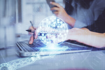 Double exposure of woman hands typing on computer and crypto market theme hologram drawing....