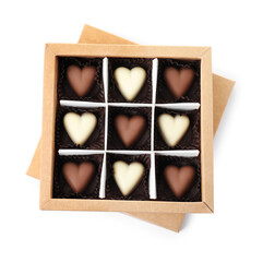 Tasty heart shaped chocolate candies in box isolated on white, top view. Valentine's day celebration