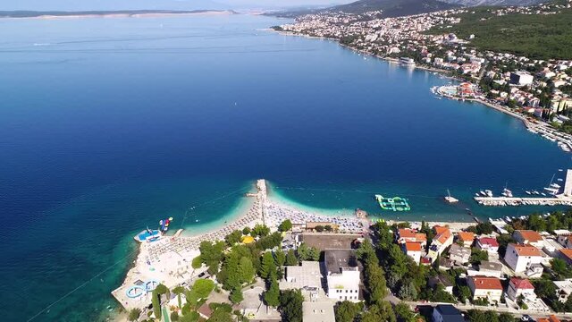 Tourist town of Selce and Poli Mora turquoise beach aerial view