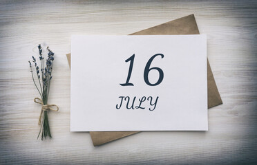 july 16. 16th day of the month, calendar date.White blank of paper with a brown envelope, dry bouquet of lavender flowers on a wooden background. Summer month, day of the year concept