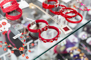 Original handmade bracelets with precious stones on the showcase of a jewelry store