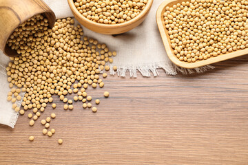Organic soy beans on wooden table, flat lay. Space for text