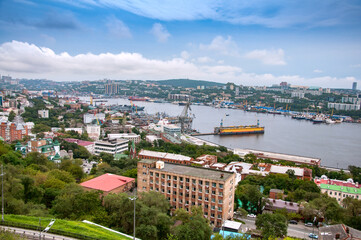 Fototapeta na wymiar Cityscape panorama of Vladivostok downtown and Zolotoy Rog (Golden Horn Bay) from the top of the Eagle's Nest hill on a sunny day