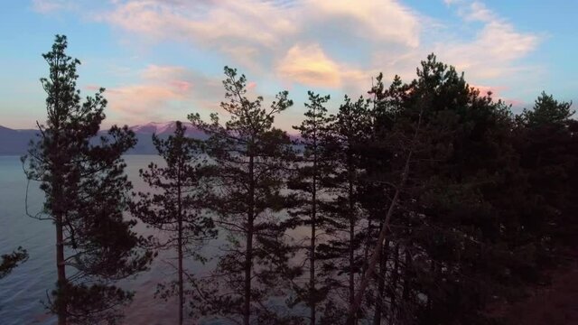 Freshwater mountains lake Sevan and beautiful sky heaven during sunset aerial drone fly over footage.