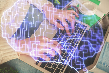 Double exposure of woman hands working on computer and brain hologram drawing. Ai concept.