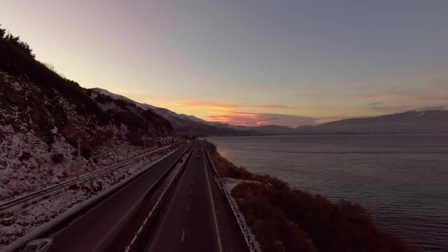 Freshwater mountains lake Sevan and beautiful sky heaven during sunset aerial drone fly over footage.