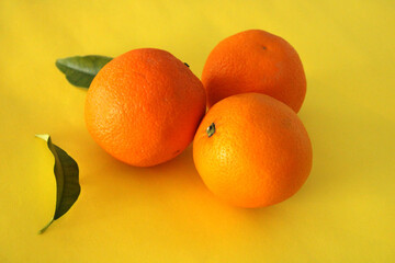 Oranges on a yellow background, fresh fruits, winter season