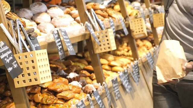 african american man in a supermarket chooses a bun