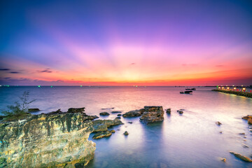 Colorful sunset in Phu Quoc Island, Vietnam moments of transition between day and night sunlight to create warm colors and rays light. Travel destination of discovery