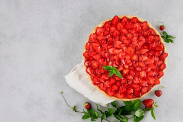 Strawberry open pie against gray background with copy space.