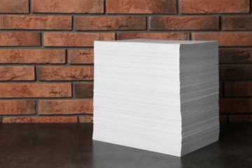 Stack of paper sheets on black table