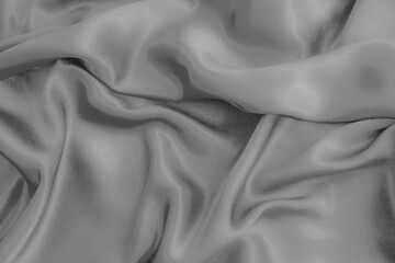 Silver silk background. .Folds. Black.