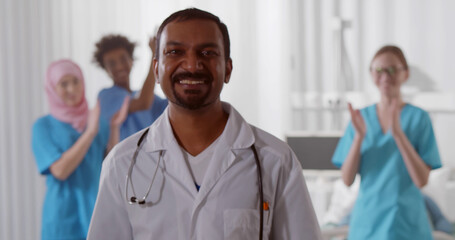 Multiethnic medical team smiling in hospital ward