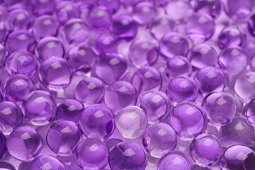 Closeup view of violet vase filler as background. Water beads