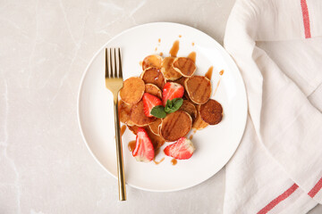 Cereal pancakes with strawberries on light grey marble table, flat lay
