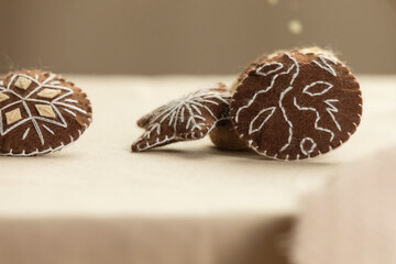 Handmade felt cookies with chocolate are on a beige background. The concept of a romantic gift for Valentine's Day, a greeting card for mothers. Felt game food, soft sweets for pretend food.