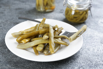 Canned green beans on grey table, closeup
