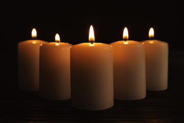 Fototapeta na wymiar Burning candles on dark background. Memory day
