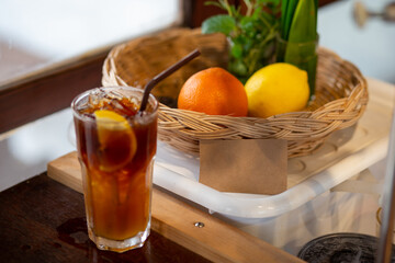 A blank paper sign waiting to fill the message next to a fruit basket in a coffee shop.