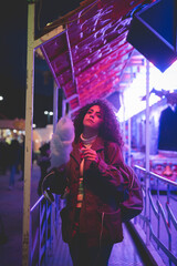 Young mixed race womanposing confident outdoors holding cotton candy