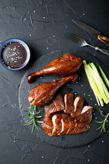Peking duck with sauce on a dark table