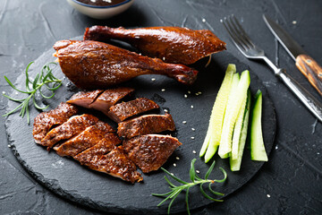 Peking duck with sauce on a dark table