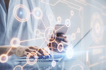 Double exposure of social network sketch hologram and woman holding and using a mobile device.