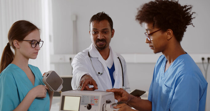 Diverse interns learning to use defibrillator for patient resuscitation