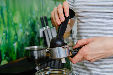 Closeup view of making ground coffee in coffee machine