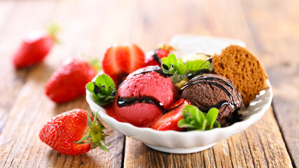 bowl of ice cream with strawberry and biscuit