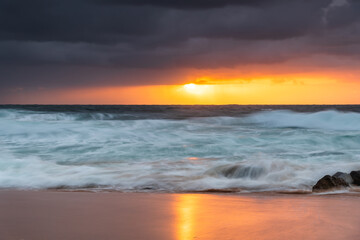A moody overcast sunrise seascape