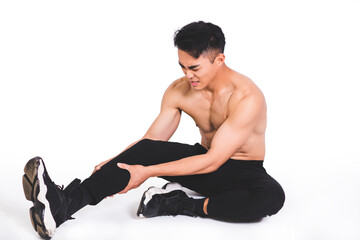 Fototapeta na wymiar muscle fitness man reaching for his leg in pain