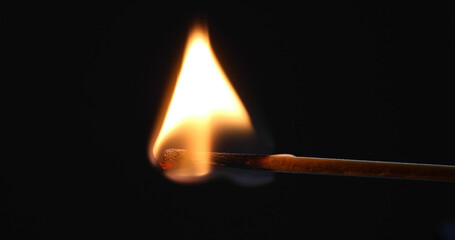 Matchstick burns with a flame