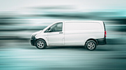 Fototapeta na wymiar White van speeding down a city street with motion blur background.