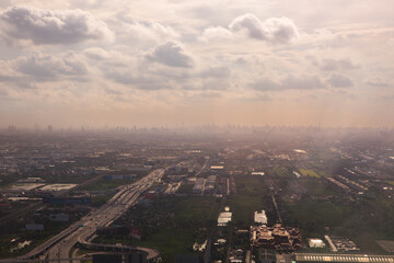 Naklejka premium Aerial view landscape of Bangkok from the plane in fog with clouds, Thailand.