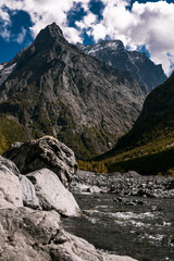 Fototapeta na wymiar Stunning view of the mountain gorge. Mountain landscape. Beautiful view of the snow-capped mountain peaks. Panoramic view of the glacier. The Caucasus mountain range. Beautiful scenery. Copy space