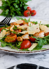 salad with arugula, shrimps and parmesan cheese