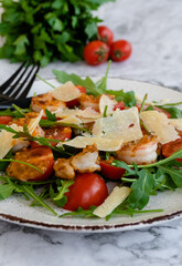 salad with arugula, shrimps and parmesan cheese