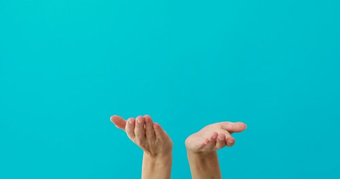Woman does begging gesture by palms on turquoise background