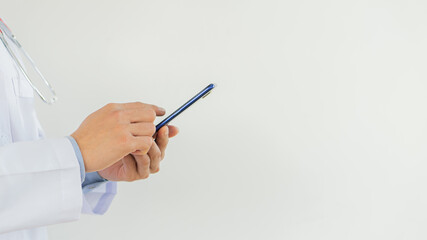 Young doctor is working mobile phone with white background