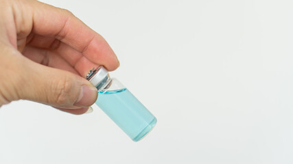 A hand holding a vial for injection with a syringe with pills or vaccines Doctor idea for epidemic or COVID 19 virus on white background