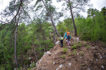 Naklejka premium A child with his mother on a hike to the mountains